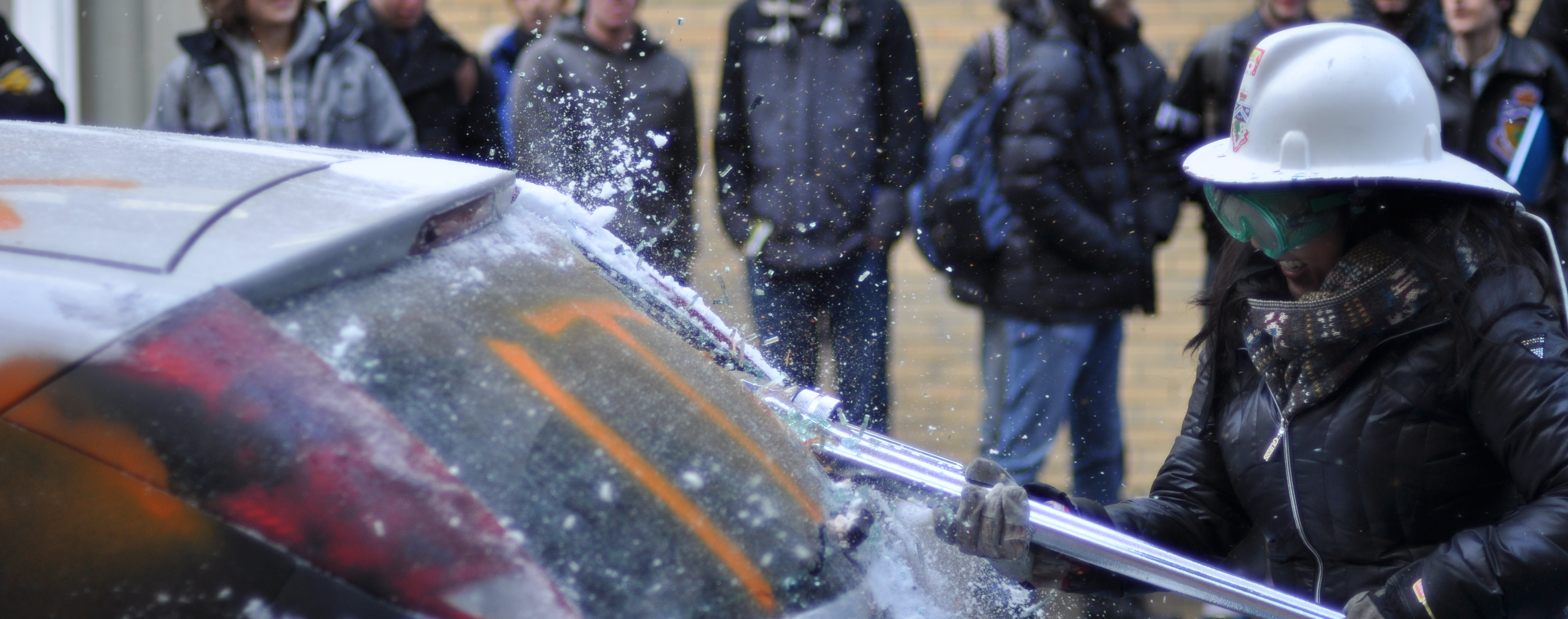 Past EngSoc President Teresa uses the Waterloo tool to smash into the back window